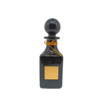 black shiny perfume oil decanter with gold lid